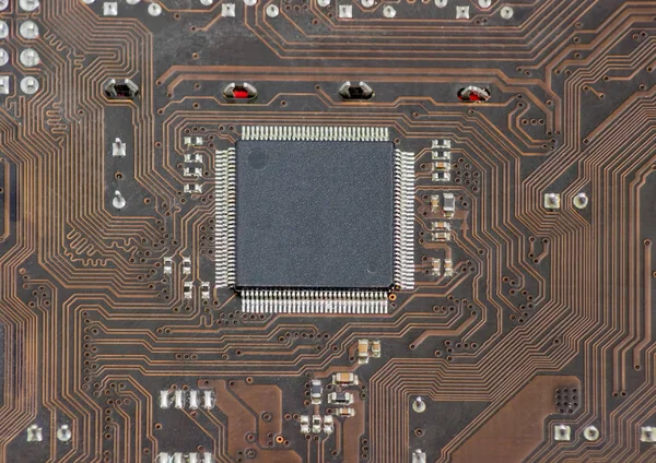 Fragment of electronic board with chip in center closeup