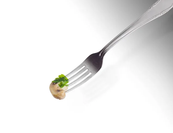 Half of the fried button mushroom on the fork — Stock Photo, Image