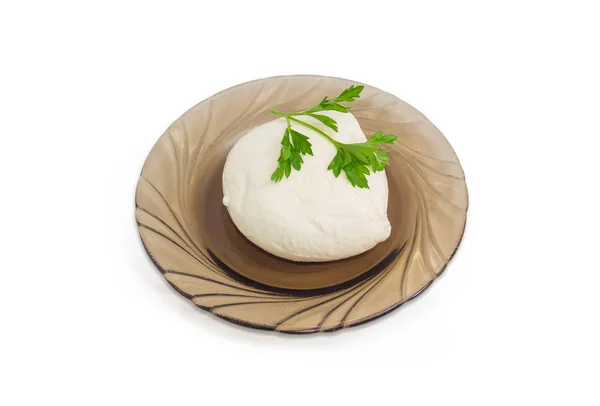 Mozzarella cheese with parsley twig on a glass saucer — Stock Photo, Image