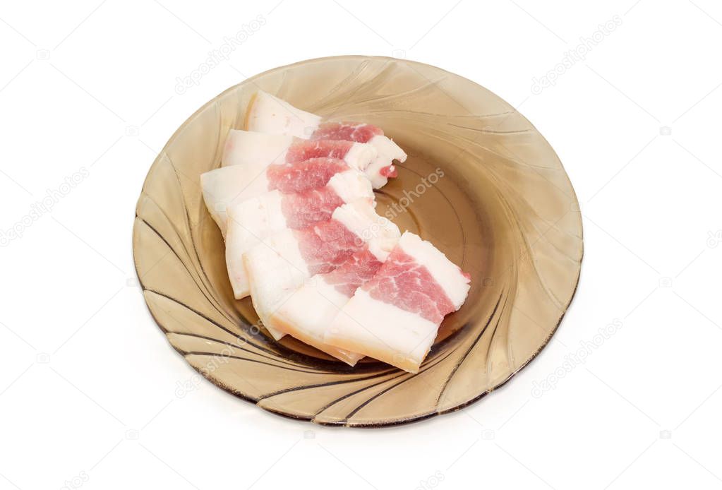Sliced pork fatback on the glass saucer