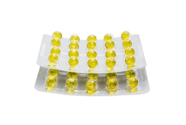 Blistry z żółte tabletki na jasnym tle — Zdjęcie stockowe