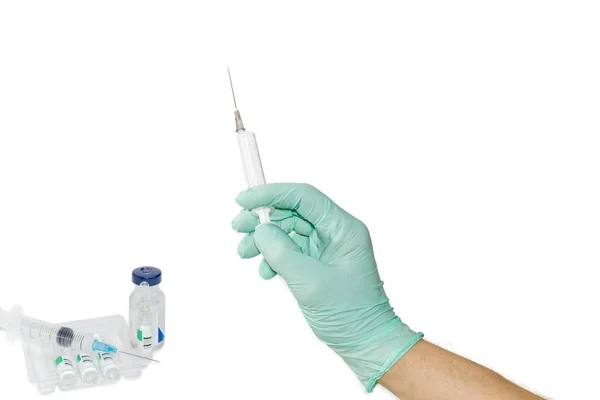 Medical syringe in a male hand wearing a medical glove — Stock Photo, Image