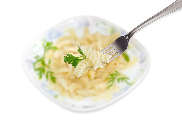 Cooked spiral pasta on fork over of dish with pasta — Stock Photo, Image