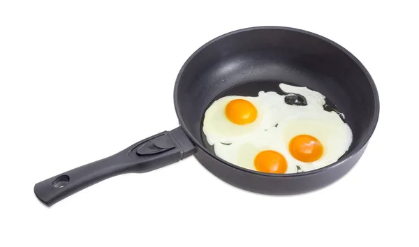 Üç kızarmış yumurta tava pişirme sırasında üzerinde — Stok fotoğraf