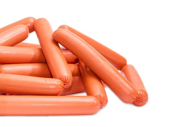 Pile of the uncooked frankfurters in the synthetic casing closeu — Stock Photo, Image