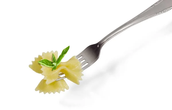 Cooked butterfly shaped pasta and basil on the fork — Stock Photo, Image