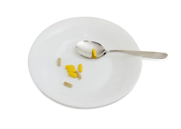 Diferentes suplementos dietéticos en el plato blanco con cuchara —  Fotos de Stock