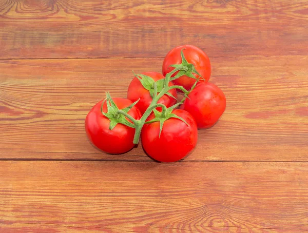 在木质表面上成熟的红番茄的分支 — 图库照片