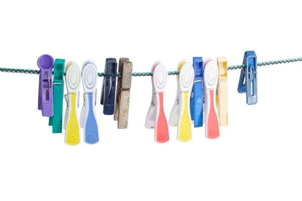 Different plastic and wooden clothespins on the clothes line — Stock Photo, Image