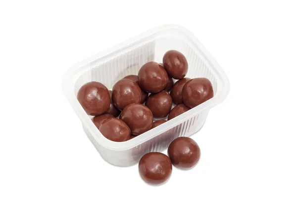 Malted milk balls covered chocolate in small plastic container Stock Picture