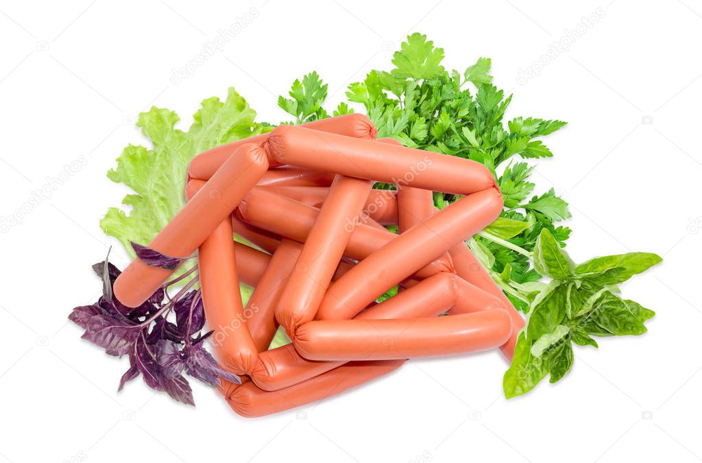 Pile of the uncooked frankfurters and various greens