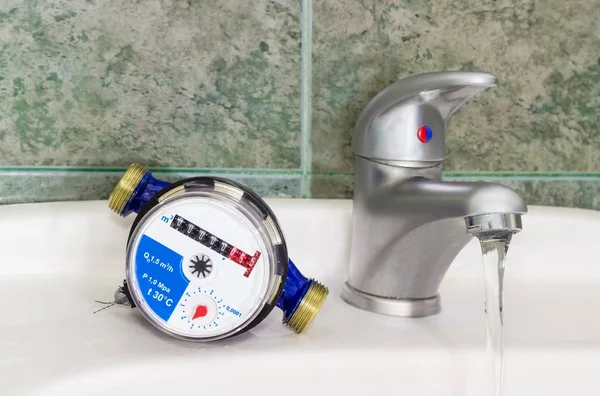 Water meter on the wash basin with handle mixer tap — Stock Photo, Image