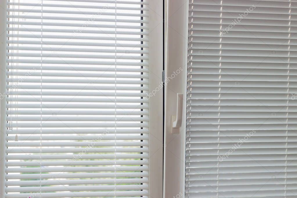 White Venetian blinds on a modern plastic window