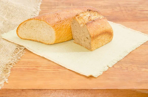 Duas metades de pão de farinha de trigo diferente em um guardanapo — Fotografia de Stock