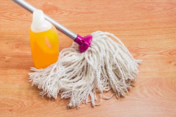 Classic mop and floor cleaner on a wooden floor — Stock Photo, Image