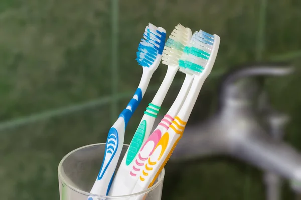 Several toothbrushes on a blurred background — Stock Photo, Image