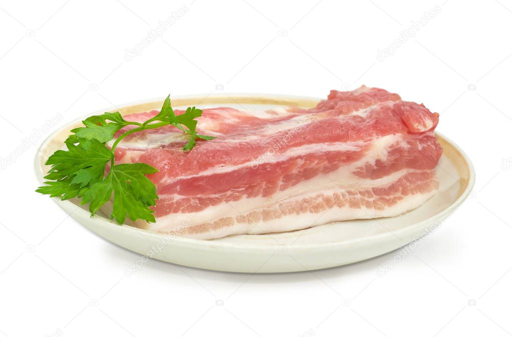 Piece of uncooked pork belly on dish