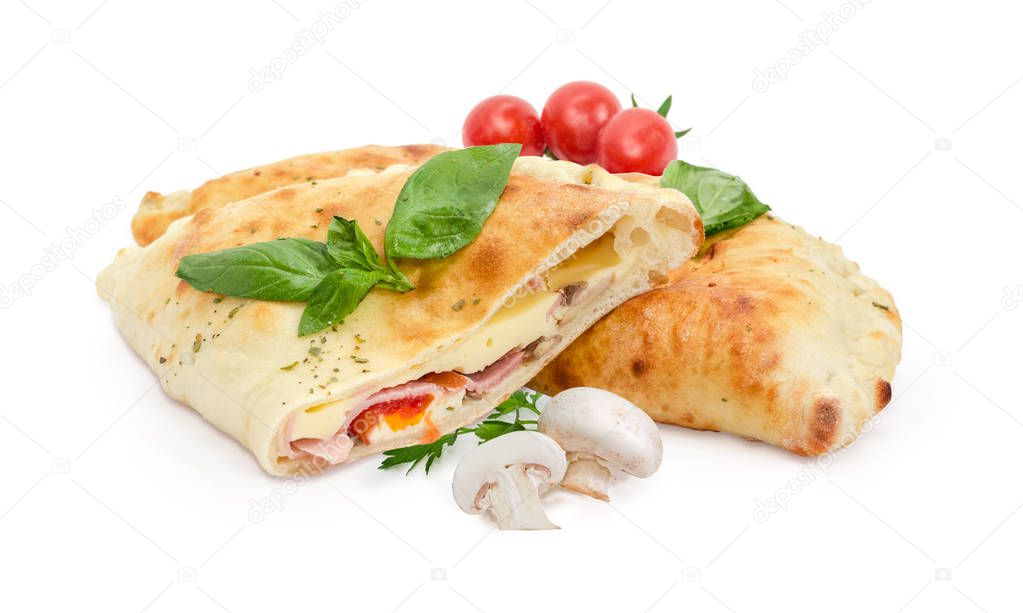 Whole and half of baked calzone, mushrooms, cherry tomatoes