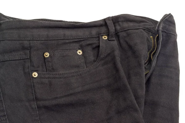 Fragment der schwarzen Jeans auf weißem Hintergrund — Stockfoto