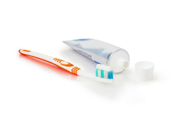 Toothbrush with toothpaste and open tube of toothpaste — Stock Photo, Image