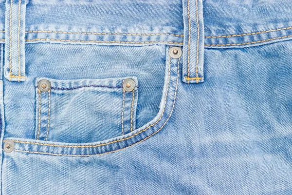 Fragment of the top of the old light blue jeans — Stock Photo, Image