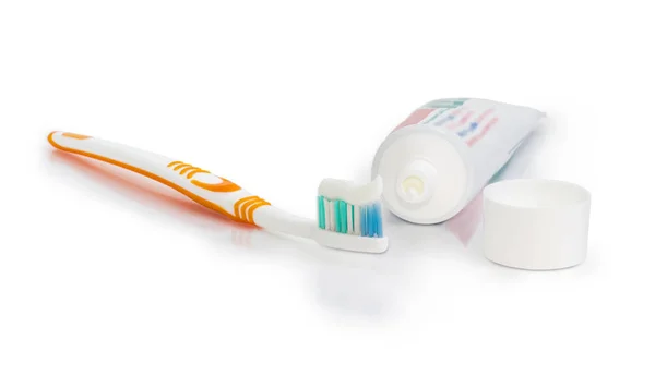 Toothbrush with toothpaste and open tube of toothpaste — Stock Photo, Image