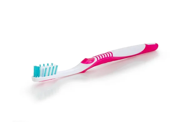 Toothbrush on a white matte surface closeup — Stock Photo, Image