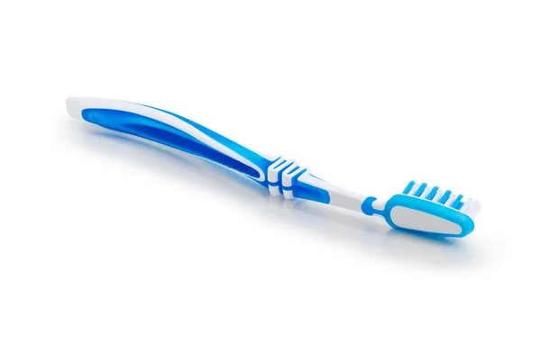 Escova de dentes em uma superfície fosca branca close-up — Fotografia de Stock