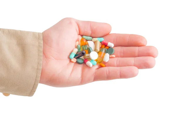 Medicijnen in de vorm van tabletten en capsules in menselijke hand — Stockfoto