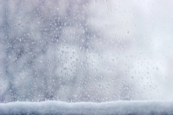 Az ablaktábla alatt egy havas háttér — Stock Fotó