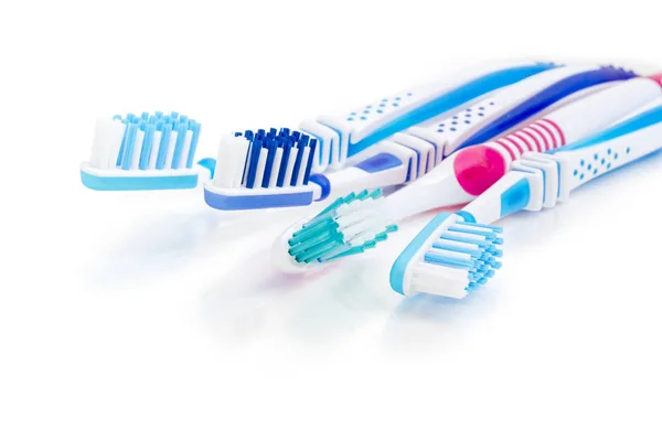 Toothbrushes on a white matte surface closeup — Stock Photo, Image