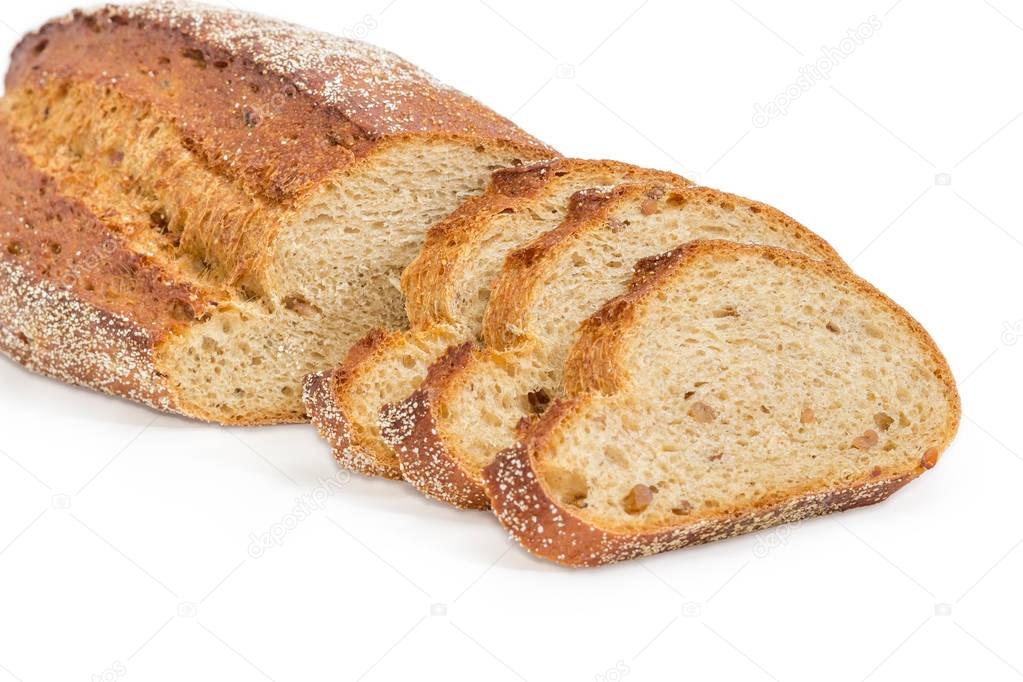 Partly sliced brown bread with whole sprouted wheat grains closeup