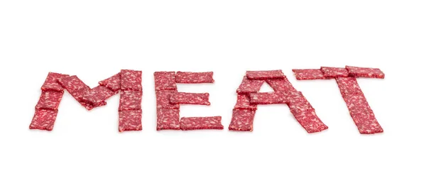 Word mięso ułożone z plasterki kiełbasy w perspektywie — Zdjęcie stockowe