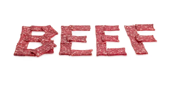 Palabra BEEF presentada con rebanadas de salchicha en perspectiva — Foto de Stock