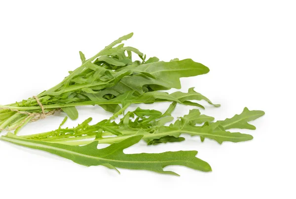 Folhas da arugula fresca closeup em um fundo branco — Fotografia de Stock