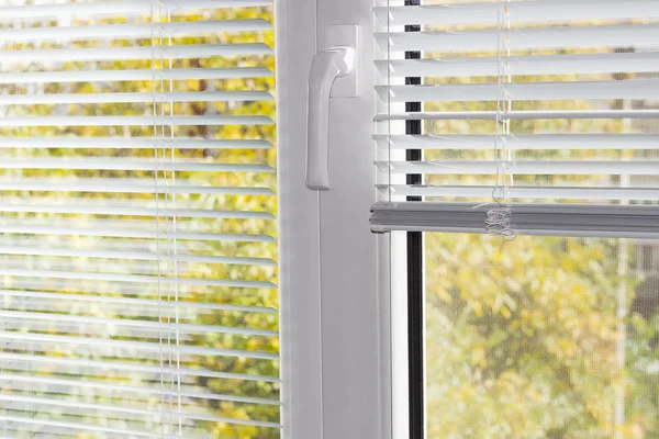 Fragment of the modern plastic window with white Venetian blinds — Stock Photo, Image