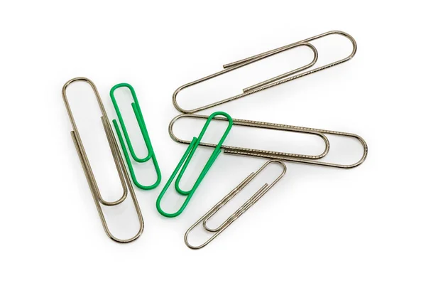 Paper clips different colors and sizes on a white background — Stock Photo, Image