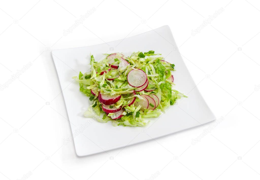 Spring salad of sliced fresh vegetables on the white dish