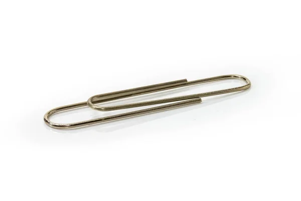 Large steel paper clip on a white background close-up — Stock Photo, Image