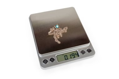 Jewelry on professional digital table top scales on white background clipart