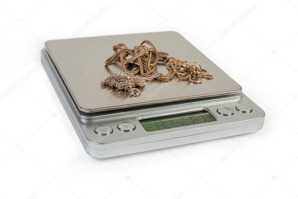 Professional digital table scales and silver jewelry on them close-up