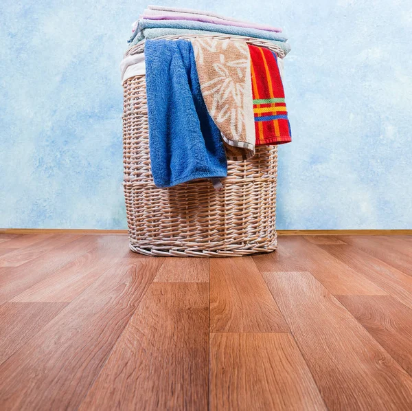 Cesta de ropa de mimbre de madera en el suelo, diferentes toallas, vista inferior — Foto de Stock