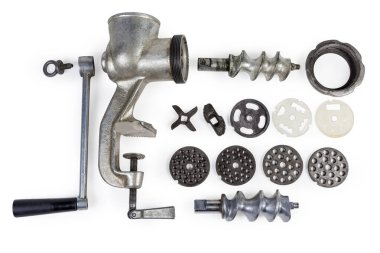Disassembled hand meat grinder and interchangeable components focus clipart