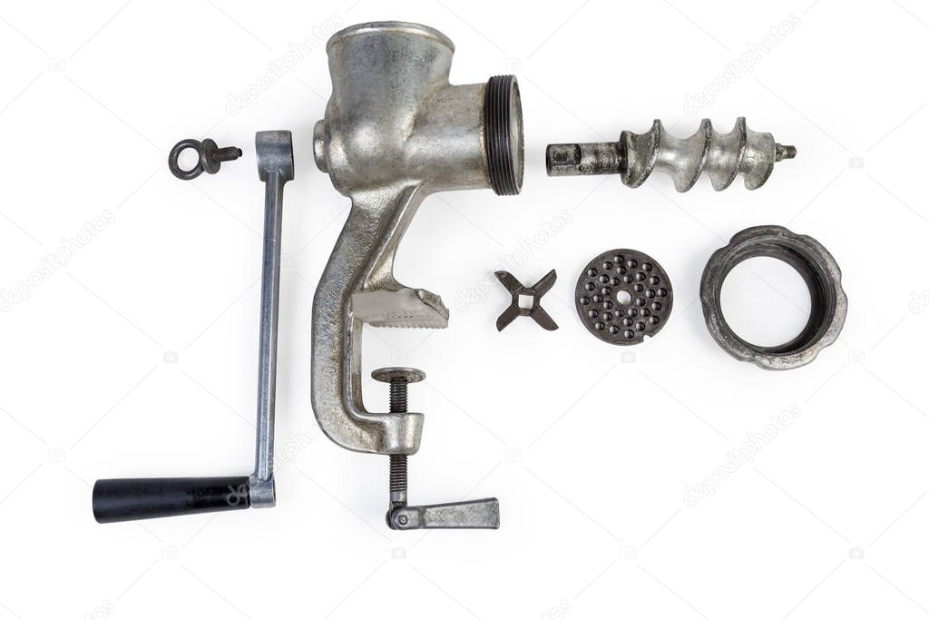 Disassembled hand meat grinder and its components on white background