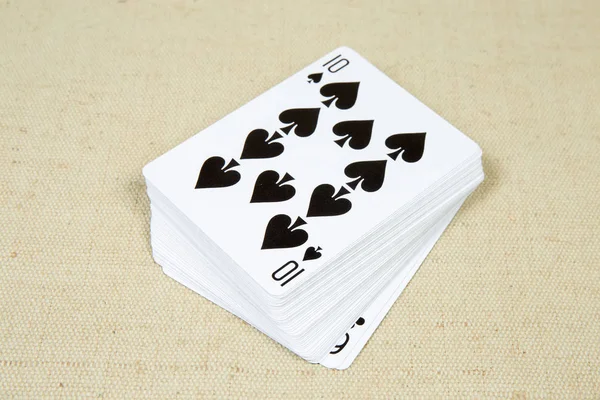 Face-up standard deck of playing cards on textile surface