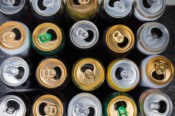 Top view of used open beverage cans on black surafce — Stock Photo, Image
