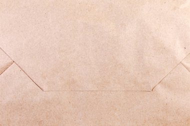 Kahverengi, beyazlatılmamış kağıt torbanın katlanmış düz tabanı. Yakın plan, doku, arka plan.