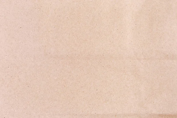 Fragment Arkusza Jasnobrązowego Niebielonego Papieru Pakowego Zbliżenie Tekstura Tło — Zdjęcie stockowe