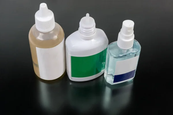 Kleine Plastikflaschen Der Verschiedenen Antiseptika Auf Einer Dunkelmatten Oberfläche — Stockfoto