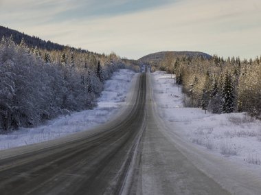 View of road passing through snow covered landscape, Regional District of Fraser-Fort George, Highway 16, Yellowhead Highway, British Columbia, Canada clipart